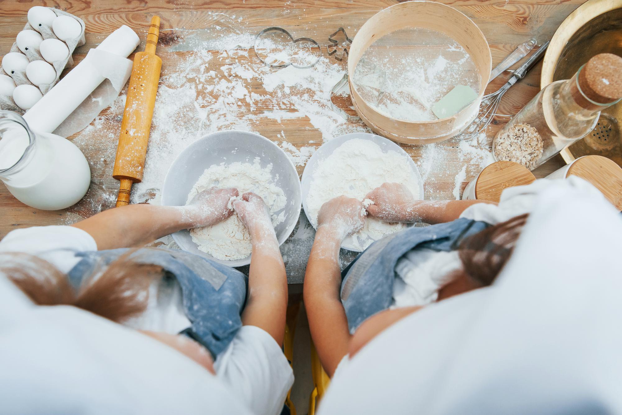 Hands kneading dough in workshop